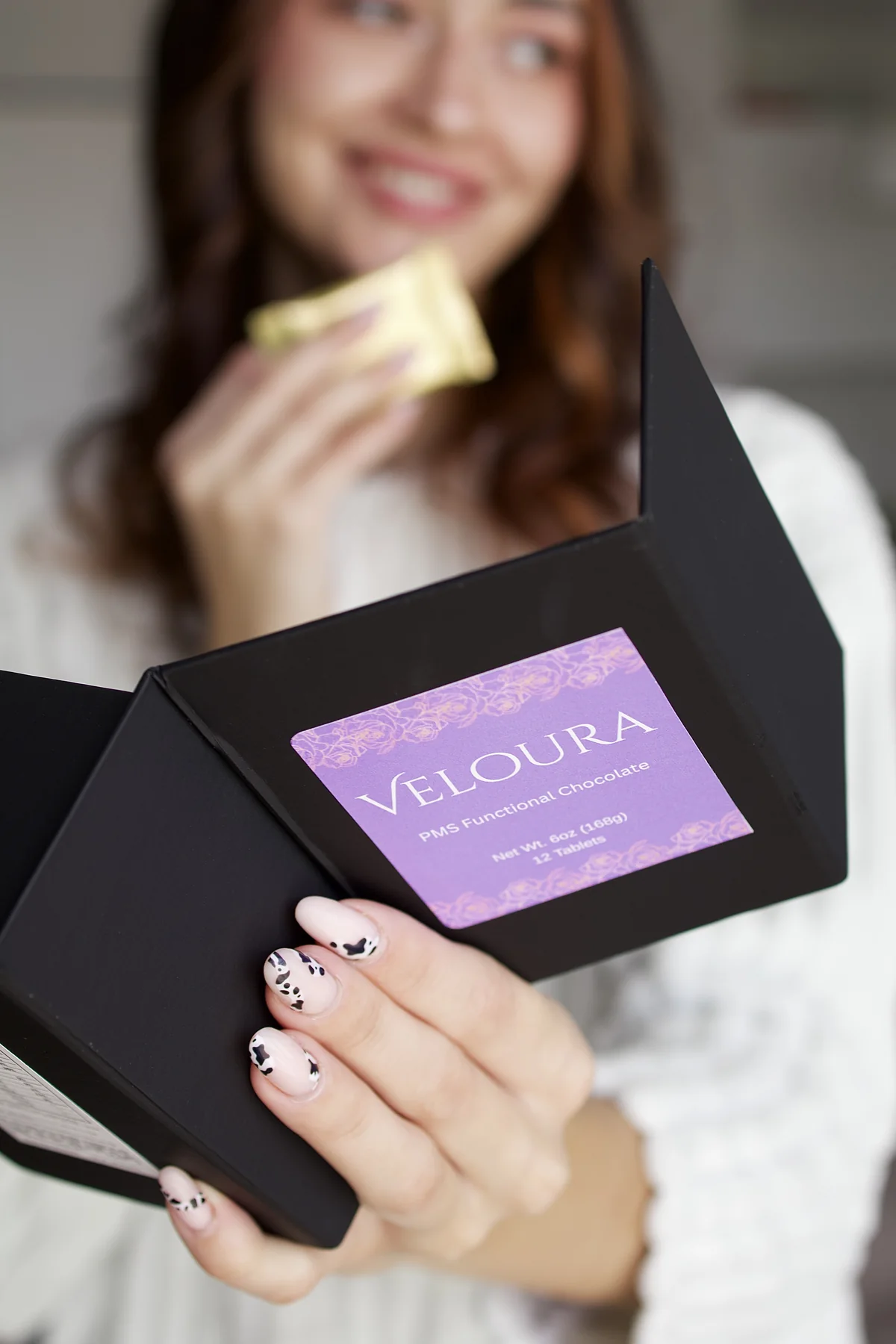 Beauty creator presenting a Veloura product box