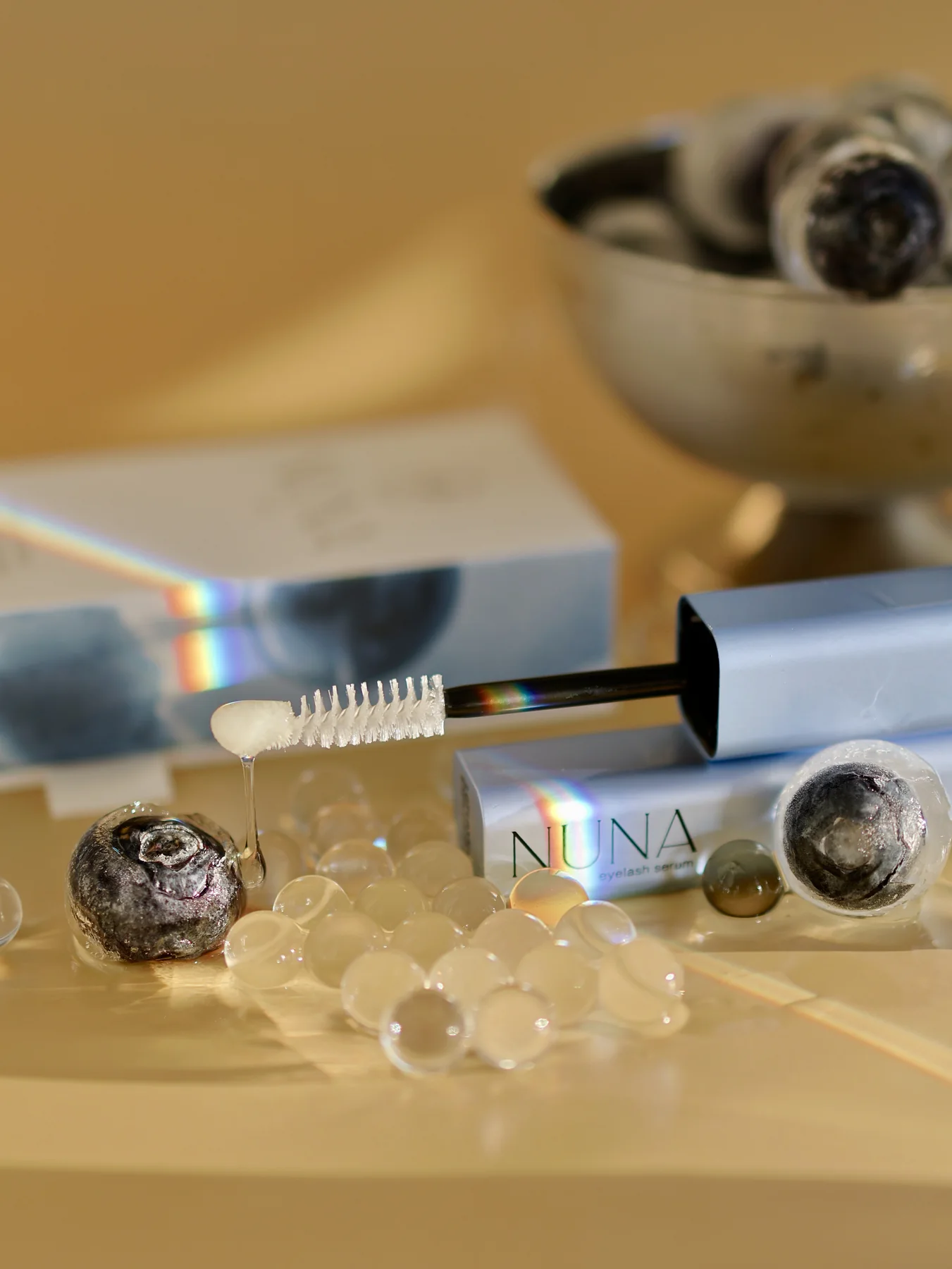 Mascara wand product photo with pearls and mirrored light
